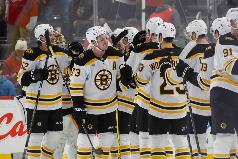 Nov 23, 2024; Detroit, Michigan, USA; The Boston Bruins celebrate their win over the Detroit Red Wing at Little Caesars Arena. Mandatory Credit: Brian Bradshaw Sevald-Imagn Images