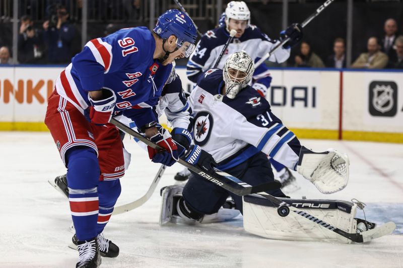 Nov 12, 2024; New York, New York, USA;  Winnipeg Jets goaltender Connor Hellebuyck (37) defends against a shot on goal attempt by New York Rangers right wing Reilly Smith (91) in the second period at Madison Square Garden. Mandatory Credit: Wendell Cruz-Imagn Images