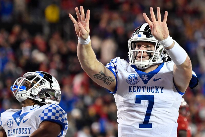 Nov 27, 2021; Louisville, Kentucky, USA;  Kentucky Wildcats quarterback Will Levis (7) celebrates after scoring his fourth touchdown against the Louisville Cardinals during the second half at Cardinal Stadium. Kentucky won 52-21. Mandatory Credit: Jamie Rhodes-USA TODAY Sports