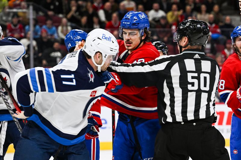 Jan 17, 2023; Montreal, Quebec, CAN; NHL linesman Scott Cherrey (50) tries to hold Montreal Canadiens defenseman Arber Xhekaj (72) and Winnipeg Jets center Adam Lowry (17) from fighting during the third period at Bell Centre. Mandatory Credit: David Kirouac-USA TODAY Sports