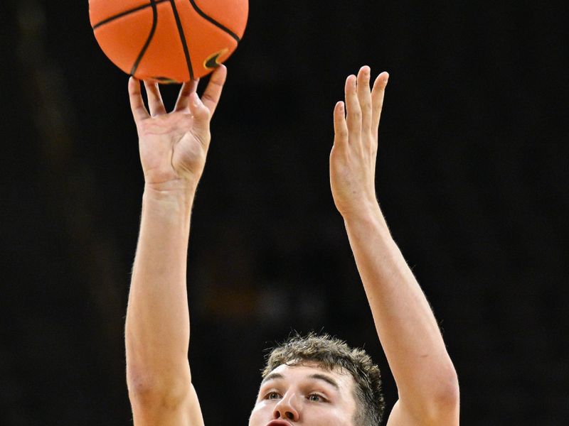 Dec 3, 2024; Iowa City, Iowa, USA; Northwestern Wildcats forward Luke Hunger (33) shoots the ball against the Iowa Hawkeyes during the first half at Carver-Hawkeye Arena. Mandatory Credit: Jeffrey Becker-Imagn Images