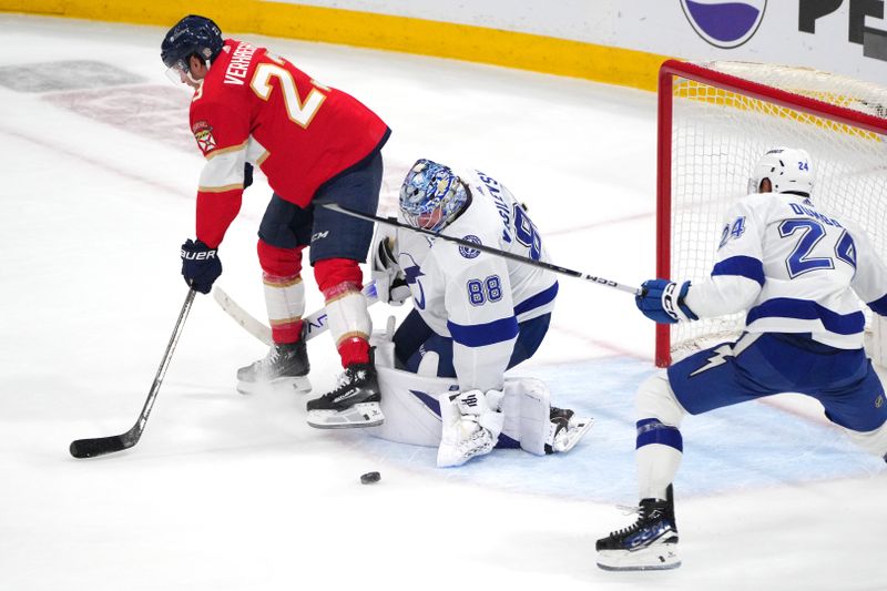 Apr 29, 2024; Sunrise, Florida, USA; Tampa Bay Lightning goaltender Andrei Vasilevskiy (88) makes a save against Florida Panthers center Carter Verhaeghe (23) during the second period in game five of the first round of the 2024 Stanley Cup Playoffs at Amerant Bank Arena. Mandatory Credit: Jim Rassol-USA TODAY Sports