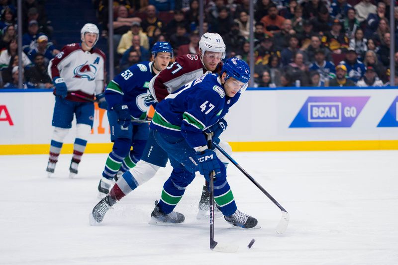 Mar 13, 2024; Vancouver, British Columbia, CAN; Colorado Avalanche forward Casey Mittelstadt (37) checks Vancouver Canucks defenseman Noah Juulsen (47) in the second period at Rogers Arena. Mandatory Credit: Bob Frid-USA TODAY Sports