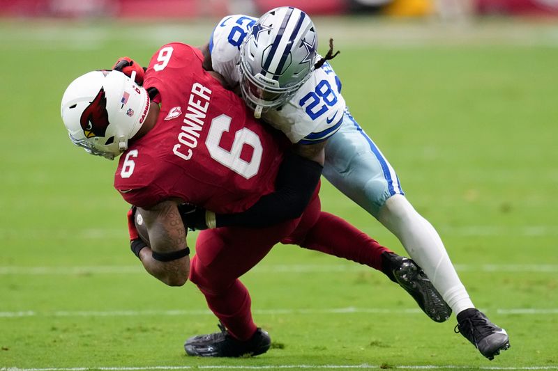 Dallas Cowboys safety Malik Hooker (28) tackles Arizona Cardinals running back James Conner (6) during the first half of an NFL football game, Sunday, Sept. 24, 2023, in Glendale, Ariz. (AP Photo/Ross D. Franklin)