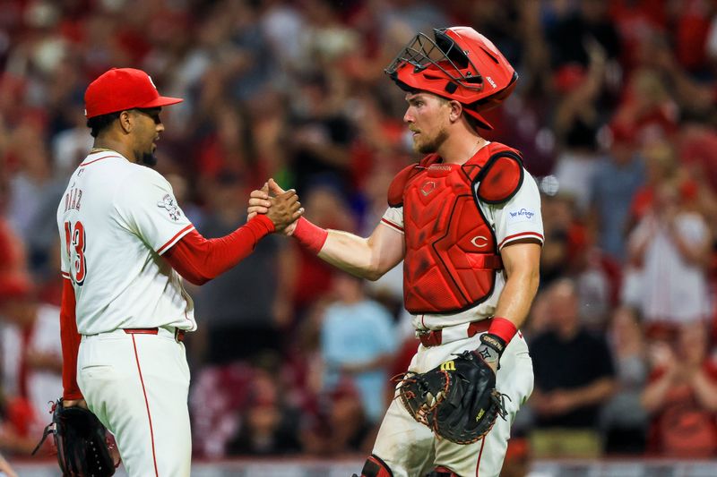 Jul 30, 2024; Cincinnati, Ohio, USA; Cincinnati Reds relief pitcher Alexis Diaz (43) shakes hands with catcher Tyler Stephenson (37) after the victory over the Chicago Cubs at Great American Ball Park. Mandatory Credit: Katie Stratman-USA TODAY Sports