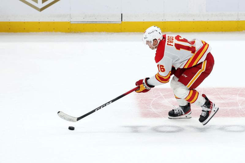 Dec 13, 2025; Los Angeles, California, USA;  Calgary Flames center Morgan Frost (16) skates with the puck in overtime against the Los Angeles Kings at Crypto.com Arena. Mandatory Credit: Kiyoshi Mio-Imagn Images