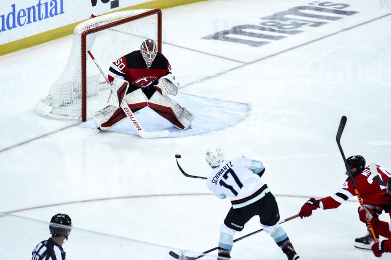 Feb 12, 2024; Newark, New Jersey, USA;  New Jersey Devils goaltender Nico Daws (50) makes a save against Seattle Kraken center Jaden Schwartz (17) during the third period at Prudential Center. Mandatory Credit: John Jones-USA TODAY Sports