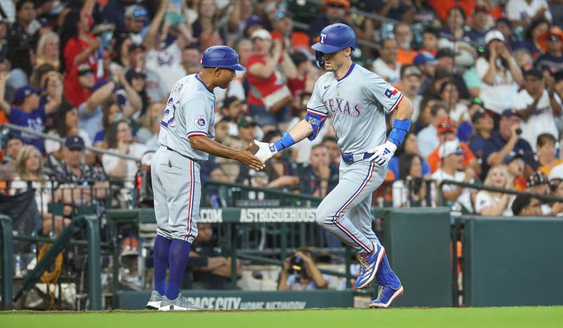 Apr 14, 2024; Houston, Texas, USA; Texas Rangers left fielder Evan Carter (32) celebrates with third base coach Tony Beasley (27) after hitting a home run during the fourth inning against the Houston Astros at Minute Maid Park. Mandatory Credit: Troy Taormina-USA TODAY Sports