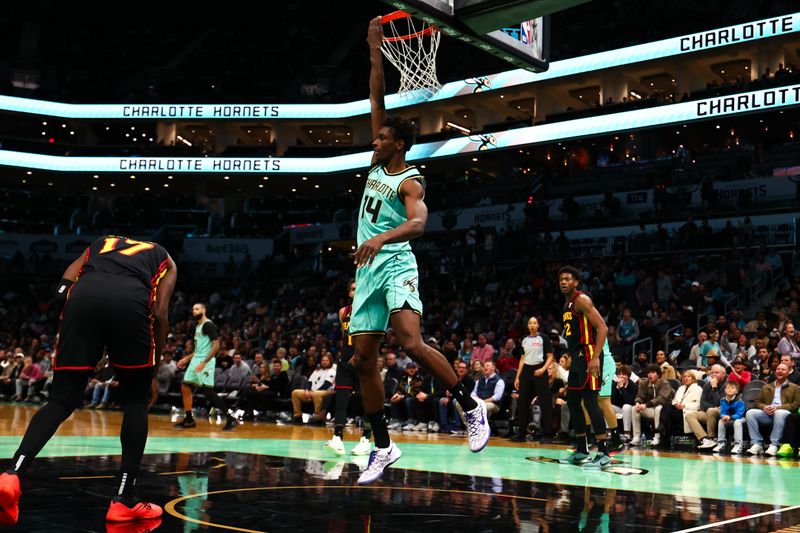 CHARLOTTE, NORTH CAROLINA - NOVEMBER 30: Moussa Diabate #14 of the Charlotte Hornets dunks the ball during the first half of a basketball game against the Atlanta Hawks at Spectrum Center on November 30, 2024 in Charlotte, North Carolina. NOTE TO USER: User expressly acknowledges and agrees that, by downloading and or using this photograph, User is consenting to the terms and conditions of the Getty Images License Agreement. (Photo by David Jensen/Getty Images)