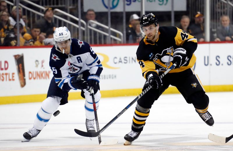 Jan 13, 2023; Pittsburgh, Pennsylvania, USA;  Pittsburgh Penguins defenseman Jan Rutta (44) moves the puck up ice against the Winnipeg Jets during the third period at PPG Paints Arena. The Jets won 4-1. Mandatory Credit: Charles LeClaire-USA TODAY Sports