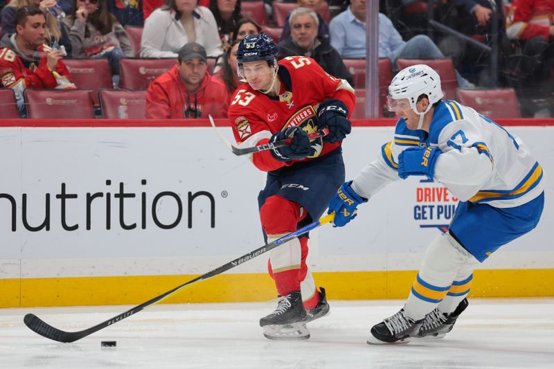Dec 20, 2025; Sunrise, Florida, USA; Florida Panthers center Jack Studnicka (53) moves the puck against St. Louis Blues defenseman Cam Fowler (17) during the second period at Amerant Bank Arena. Mandatory Credit: Sam Navarro-Imagn Images