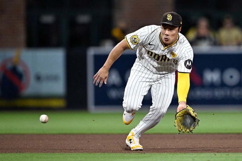 Apr 30, 2024; San Diego, California, USA; San Diego Padres shortstop Ha-Seong Kim (7) fields a ground ball during the fifth inning against the Cincinnati Reds at Petco Park. Mandatory Credit: Orlando Ramirez-USA TODAY Sports