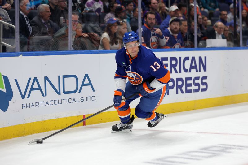 Oct 21, 2025; Elmont, New York, USA; New York Islanders center Mathew Barzal (13) skates with the puck against the San Jose Sharks during the second period at UBS Arena. Mandatory Credit: Brad Penner-Imagn Images
