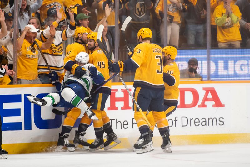 Apr 28, 2024; Nashville, Tennessee, USA; Vancouver Canucks center Elias Pettersson (40) gets hit as Nashville Predators center Mark Jankowski (17) celebrates his goal during the first period in game four of the first round of the 2024 Stanley Cup Playoffs at Bridgestone Arena. Mandatory Credit: Steve Roberts-USA TODAY Sports