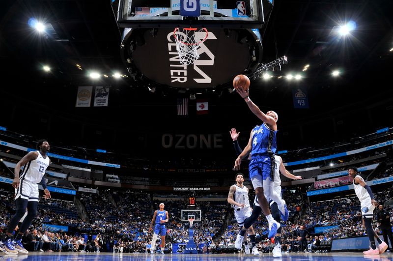 ORLANDO, FL - MARCH 30: Jalen Suggs #4 of the Orlando Magic drives to the basket during the game against the Memphis Grizzlies on March 30, 2024 at the Kia Center in Orlando, Florida. NOTE TO USER: User expressly acknowledges and agrees that, by downloading and or using this photograph, User is consenting to the terms and conditions of the Getty Images License Agreement. Mandatory Copyright Notice: Copyright 2024 NBAE (Photo by Fernando Medina/NBAE via Getty Images)