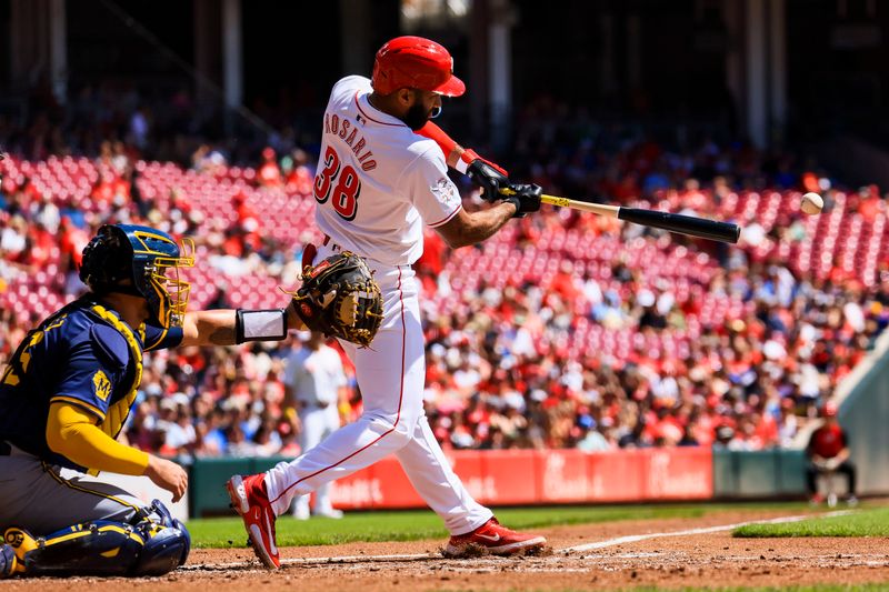 Sep 1, 2024; Cincinnati, Ohio, USA; Cincinnati Reds designated hitter Amed Rosario (38) hits a single against the Milwaukee Brewers in the second inning at Great American Ball Park. Mandatory Credit: Katie Stratman-USA TODAY Sports