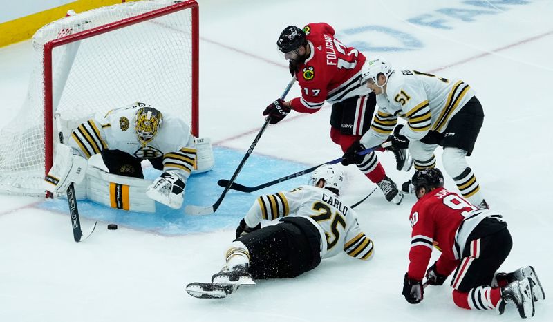 Oct 24, 2023; Chicago, Illinois, USA; Boston Bruins goaltender Jeremy Swayman (1) makes a save against Chicago Blackhawks left wing Nick Foligno (17) during the third period at United Center. Mandatory Credit: David Banks-USA TODAY Sports