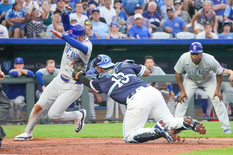 Jul 26, 2024; Kansas City, Missouri, USA; Kansas City Royals catcher Salvador Perez (13) gets the tag for an out on Chicago Cubs designated hitter Mike Tauchman (40) at home plate in the fifth inning at Kauffman Stadium. Mandatory Credit: Denny Medley-USA TODAY Sports