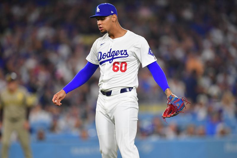 Sep 24, 2024; Los Angeles, California, USA; Los Angeles Dodgers pitcher Edgardo Henriquez (60) reacts against the San Diego Padres during the sixth inning in his major league debut at Dodger Stadium. Mandatory Credit: Gary A. Vasquez-Imagn Images