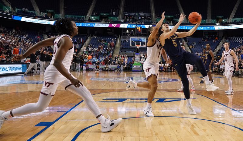 Mar 7, 2023; Greensboro, NC, USA; Notre Dame Fighting Irish guard Cormac Ryan (5) drives to the basket against the Virginia Tech Hokies during the second half of the first round of the ACC tournament at Greensboro Coliseum. Mandatory Credit: John David Mercer-USA TODAY Sports