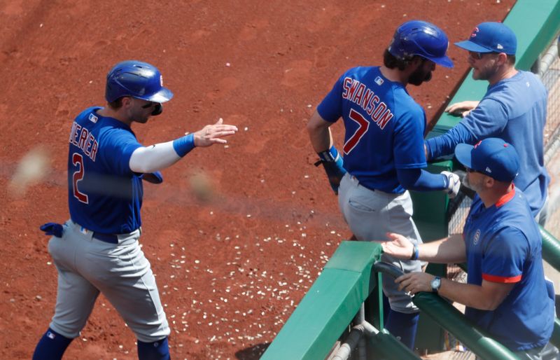 Aug 27, 2023; Pittsburgh, Pennsylvania, USA;  Chicago Cubs second baseman Nico Hoerner (2) and shortstop Dansby Swanson (7) high-five at the dugout after both players scored runs against the Pittsburgh Pirates during the fifth inning at PNC Park. Mandatory Credit: Charles LeClaire-USA TODAY Sports