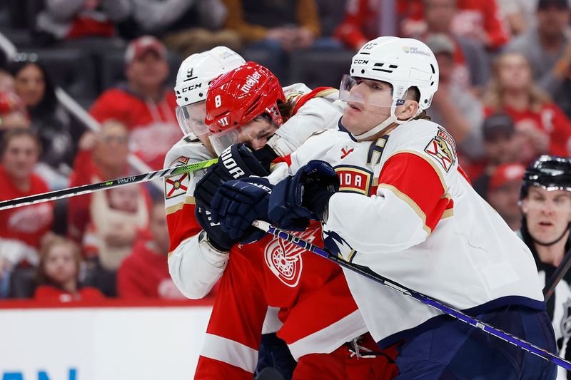 Mar 2, 2024; Detroit, Michigan, USA; Florida Panthers center Sam Bennett (9) and center Evan Rodrigues (17) sandwich Detroit Red Wings defenseman Ben Chiarot (8) in the third period at Little Caesars Arena. Mandatory Credit: Rick Osentoski-USA TODAY Sports