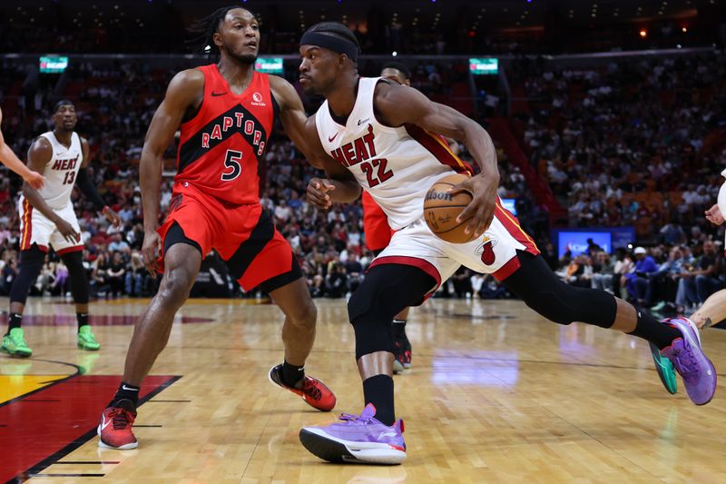 MIAMI, FLORIDA - APRIL 12: Jimmy Butler #22 of the Miami Heat drives to the basket against Immanuel Quickley #5 of the Toronto Raptors during the second quarter of the game at Kaseya Center on April 12, 2024 in Miami, Florida. NOTE TO USER: User expressly acknowledges and agrees that, by downloading and or using this photograph, User is consenting to the terms and conditions of the Getty Images License Agreement. (Photo by Megan Briggs/Getty Images)