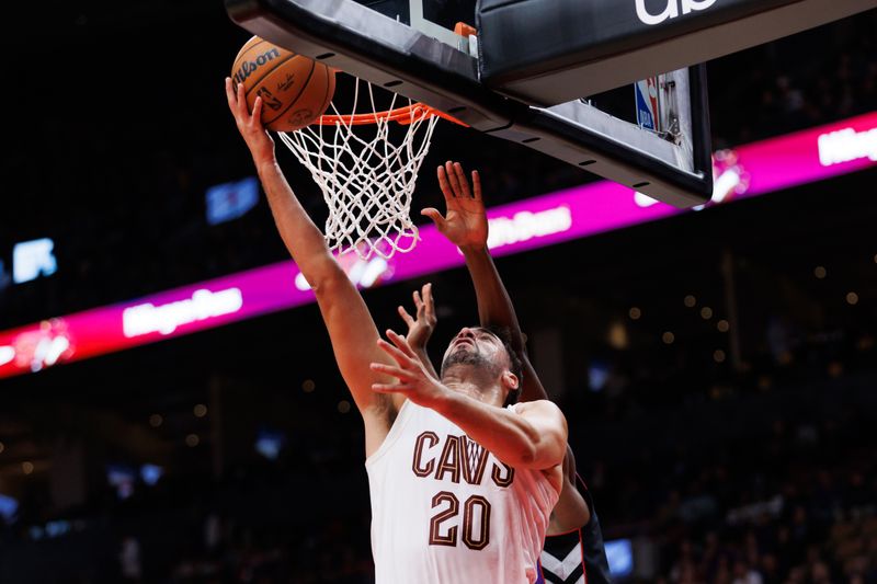 TORONTO, CANADA - OCTOBER 23: Georges Niang #20 of the Cleveland Cavaliers drives to the net against the Toronto Raptors in second half at Scotiabank Arena on October 23, 2024 in Toronto, Ontario, Canada. NOTE TO USER: User expressly acknowledges and agrees that, by downloading and or using this photograph, User is consenting to the terms and conditions of the Getty Images License Agreement. (Photo by Cole Burston/Getty Images)