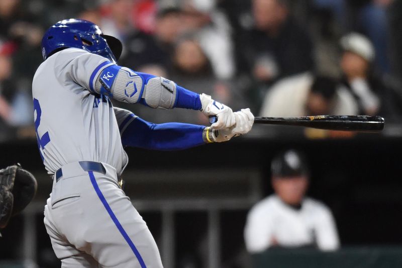 Apr 15, 2024; Chicago, Illinois, USA; Kansas City Royals center fielder Kyle Isbel (28) hits a one-run RBI single during the fifth inning against the Chicago White Sox at Guaranteed Rate Field. Mandatory Credit: Patrick Gorski-USA TODAY Sports