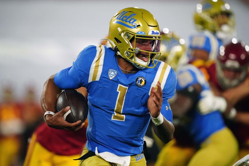 Dec 12, 2020; Pasadena, California, USA; UCLA Bruins quarterback Dorian Thompson-Robinson (1) carries the ball in the second quarter against the Southern California Trojans  at Rose Bowl. Mandatory Credit: Kirby Lee-USA TODAY Sports