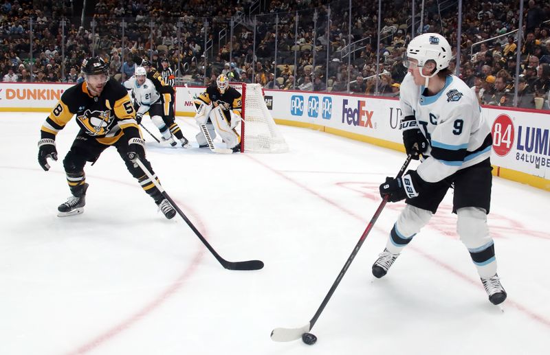 Nov 23, 2024; Pittsburgh, Pennsylvania, USA;  Utah Hockey Club center Clayton Keller (9) looks to pass the puck as Pittsburgh Penguins defenseman Kris Letang (58) defends during the second period at PPG Paints Arena. Mandatory Credit: Charles LeClaire-Imagn Images