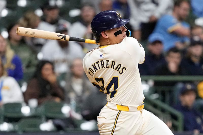 May 9, 2024; Milwaukee, Wisconsin, USA;  Milwaukee Brewers designated hitter William Contreras (24) hits an RBI single during the seventh inning against the St. Louis Cardinals at American Family Field. Mandatory Credit: Jeff Hanisch-USA TODAY Sports