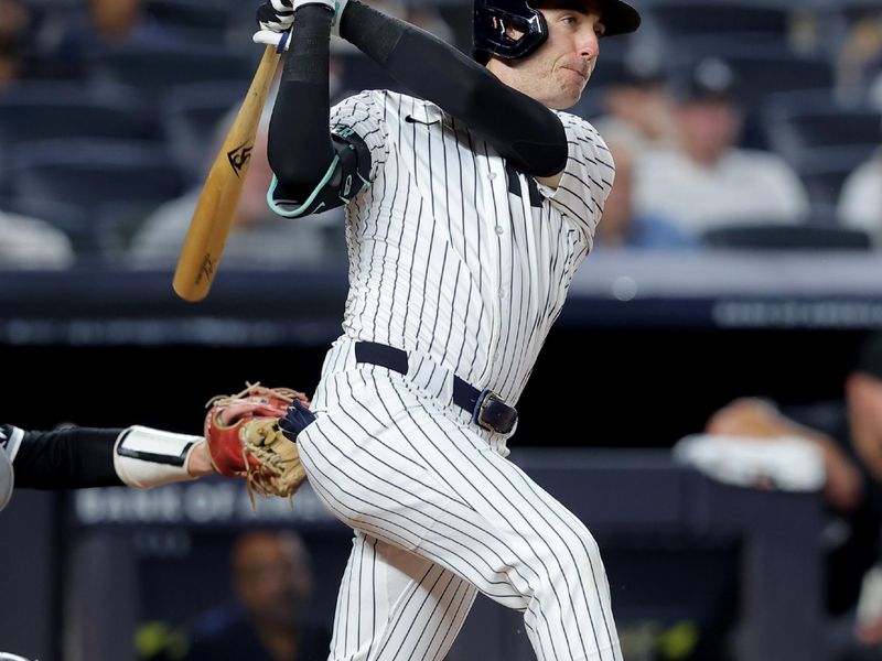 Sep 25, 2025; Bronx, New York, USA; New York Yankees left fielder Cody Berlinger (35) follows through on a single against the Chicago White Sox during the fifth inning at Yankee Stadium. Mandatory Credit: Brad Penner-Imagn Images