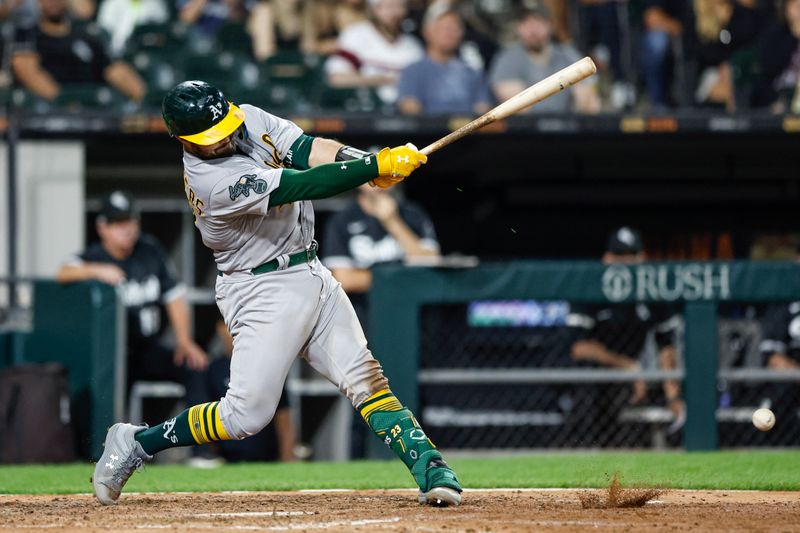 Aug 25, 2023; Chicago, Illinois, USA; Oakland Athletics catcher Shea Langeliers (23) hits an RBI-single against the Chicago White Sox during the sixth inning at Guaranteed Rate Field. Mandatory Credit: Kamil Krzaczynski-USA TODAY Sports