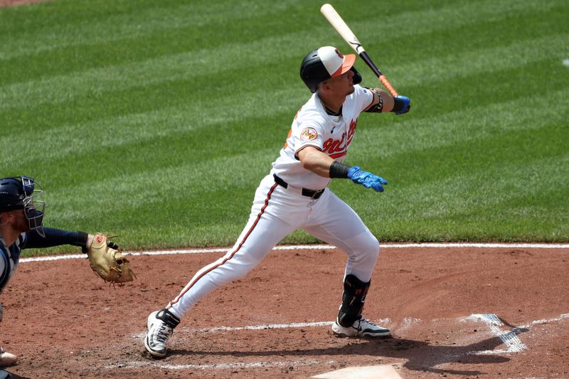 Jun 29, 2025; Baltimore, Maryland, USA; Baltimore Orioles third baseman Ramon Urias (29) hits a sacrifice fly during the fifth inning against the Tampa Bay Rays at Oriole Park at Camden Yards. Mandatory Credit: Daniel Kucin Jr.-Imagn Images