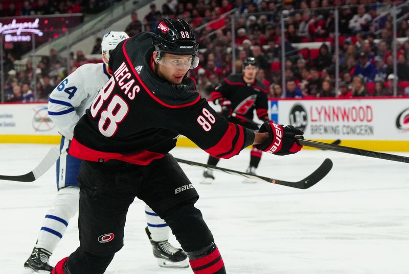 Mar 24, 2024; Raleigh, North Carolina, USA;  Carolina Hurricanes center Martin Necas (88) takes a shot against the Toronto Maple Leafs during the first period at PNC Arena. Mandatory Credit: James Guillory-USA TODAY Sports