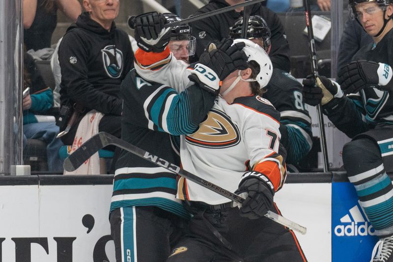 Feb 29, 2024; San Jose, California, USA; San Jose Sharks defenseman Kyle Burroughs (4) and Anaheim Ducks right wing Frank Vatrano (77) fight during the third period at SAP Center at San Jose. Mandatory Credit: Stan Szeto-USA TODAY Sports