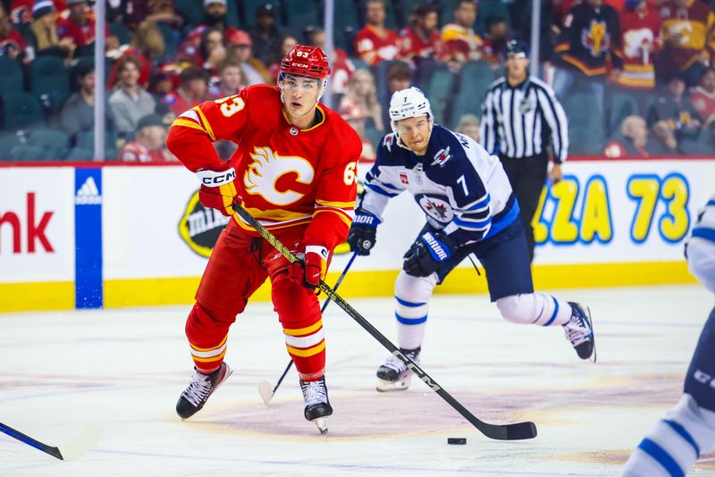 Oct 11, 2023; Calgary, Alberta, CAN; Calgary Flames center Adam Ruzicka (63) controls the puck against the Winnipeg Jets during the second period at Scotiabank Saddledome. Mandatory Credit: Sergei Belski-USA TODAY Sports