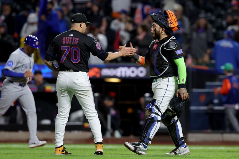 May 9, 2025; New York City, New York, USA; New York Mets relief pitcher Jose Butto (70) and catcher Francisco Alvarez (4) celebrate after defeating the Chicago Cubs at Citi Field. Mandatory Credit: Brad Penner-Imagn Images