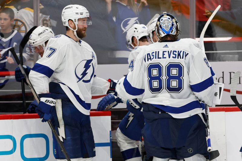 Dec 23, 2023; Washington, District of Columbia, USA; Tampa Bay Lightning goaltender Andrei Vasilevskiy (88) celebrates with Lightning defenseman Victor Hedman (77) after their game against the Washington Capitals at Capital One Arena. Mandatory Credit: Geoff Burke-USA TODAY Sports