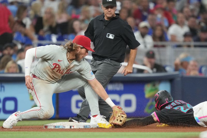 Sep 6, 2025; Miami, Florida, USA;  Miami Marlins’ Maximo Acosta (24) gets tagged out trying to steal third base by Philadelphia Phillies’ Alec Bohm (28) in the seventh inning at loanDepot Park. Mandatory Credit: Jim Rassol-Imagn Images