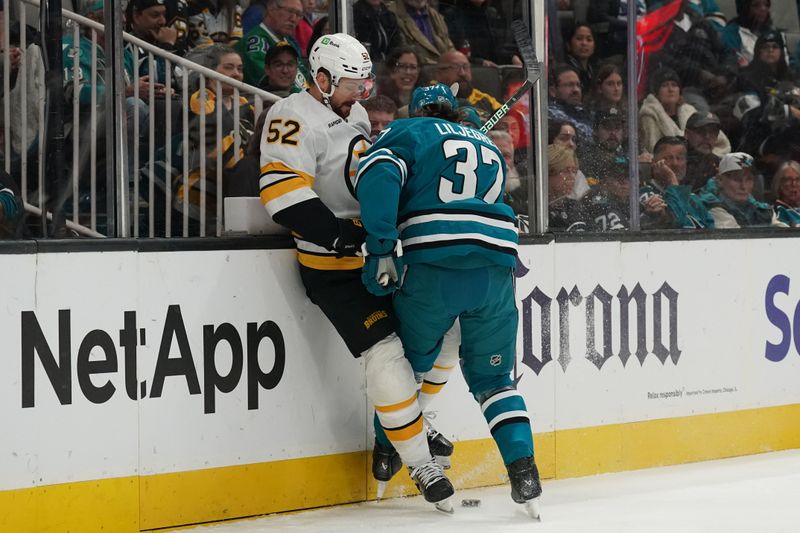 Nov 23, 2025; San Jose, California, USA;  Boston Bruins center Sean Kuraly (52) and San Jose Sharks defenseman Timothy Liljegren (37) battle for the puck in the first period at SAP Center in San Jose. Mandatory Credit: David Gonzales-Imagn Images