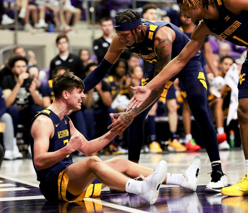 Feb 12, 2024; Fort Worth, Texas, USA;  West Virginia Mountaineers guard Kerr Kriisa (3) celebrates with teammates after drawing a charging foul during the first half against the TCU Horned Frogs at Ed and Rae Schollmaier Arena. Mandatory Credit: Kevin Jairaj-USA TODAY Sports