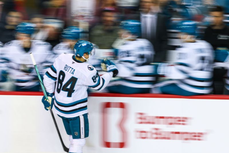 Apr 13, 2025; Calgary, Alberta, CAN; San Jose Sharks defenseman Jan Rutta (84) celebrates his goal with teammates against the Calgary Flames during the second period at Scotiabank Saddledome. Mandatory Credit: Sergei Belski-Imagn Images