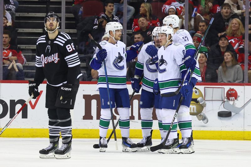 Jan 6, 2024; Newark, New Jersey, USA; Vancouver Canucks center J.T. Miller (9) celebrates his goal against the New Jersey Devils during the second period at Prudential Center. Mandatory Credit: Ed Mulholland-USA TODAY Sports