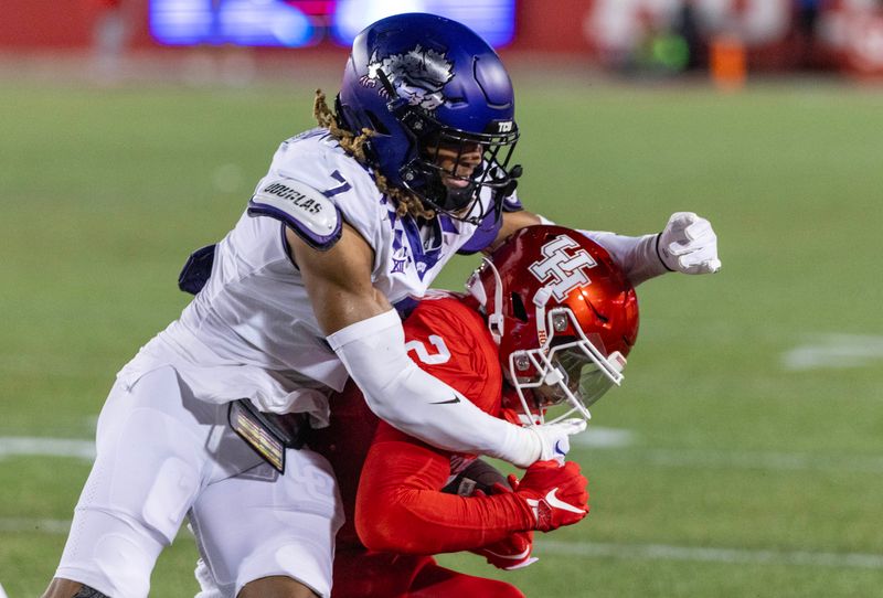 Sep 16, 2023; Houston, Texas, USA; Houston Cougars wide receiver Matthew Golden (2) is tackled by TCU Horned Frogs cornerback Channing Canada (7) in the first half at TDECU Stadium. Mandatory Credit: Thomas Shea-USA TODAY Sports