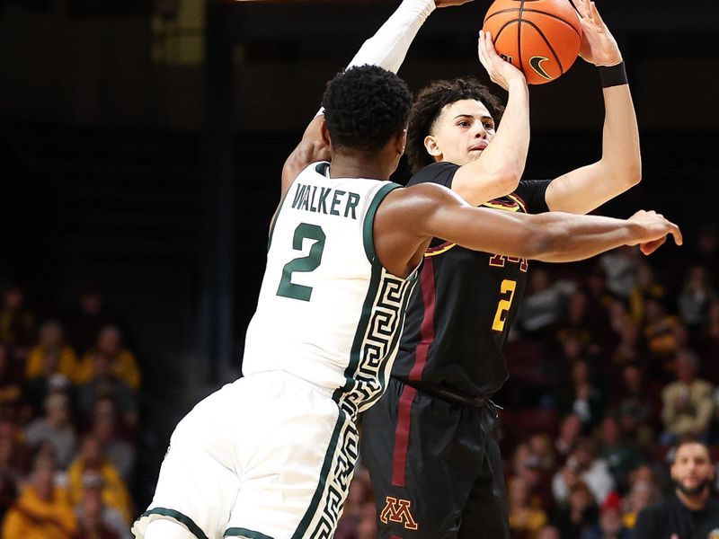 Feb 6, 2024; Minneapolis, Minnesota, USA; Minnesota Golden Gophers guard Mike Mitchell Jr. (2) shoots as Michigan State Spartans guard Tyson Walker (2) defends during the first half at Williams Arena. Mandatory Credit: Matt Krohn-USA TODAY Sports