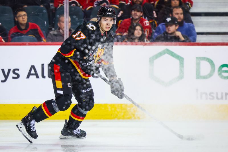 Dec 9, 2023; Calgary, Alberta, CAN; Calgary Flames center Yegor Sharangovich (17) controls the puck against the New Jersey Devils during the second period at Scotiabank Saddledome. Mandatory Credit: Sergei Belski-USA TODAY Sports