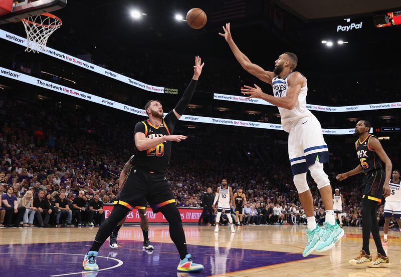 PHOENIX, ARIZONA - APRIL 26: Rudy Gobert #27 of the Minnesota Timberwolves attempts a shot over Jusuf Nurkic #20 of the Phoenix Suns during the first half of game three of the Western Conference First Round Playoffs at Footprint Center on April 26, 2024 in Phoenix, Arizona. NOTE TO USER: User expressly acknowledges and agrees that, by downloading and or using this photograph, User is consenting to the terms and conditions of the Getty Images License Agreement. NOTE TO USER: User expressly acknowledges and agrees that, by downloading and or using this photograph, User is consenting to the terms and conditions of the Getty Images License Agreement. ? (Photo by Christian Petersen/Getty Images)