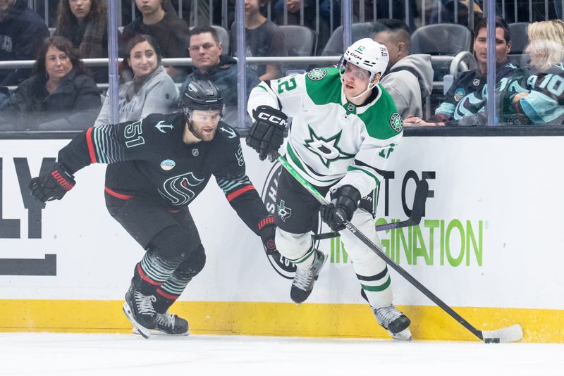 Nov 26, 2025; Seattle, Washington, USA; Dallas Stars forward Radek Faksa (12) skates against Seattle Kraken forward Shane Wright (51) during the third period at Climate Pledge Arena. Mandatory Credit: Stephen Brashear-Imagn Images